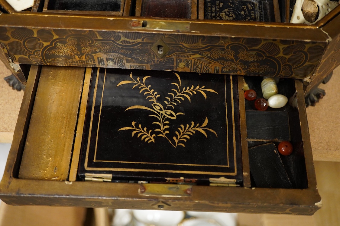 Three 19th-century Chinese gilt-decorated black lacquer sewing boxes, two containing bone sewing accessories, together with a similar tea chest (4) largest box- 33.3cm wide x 20cm high